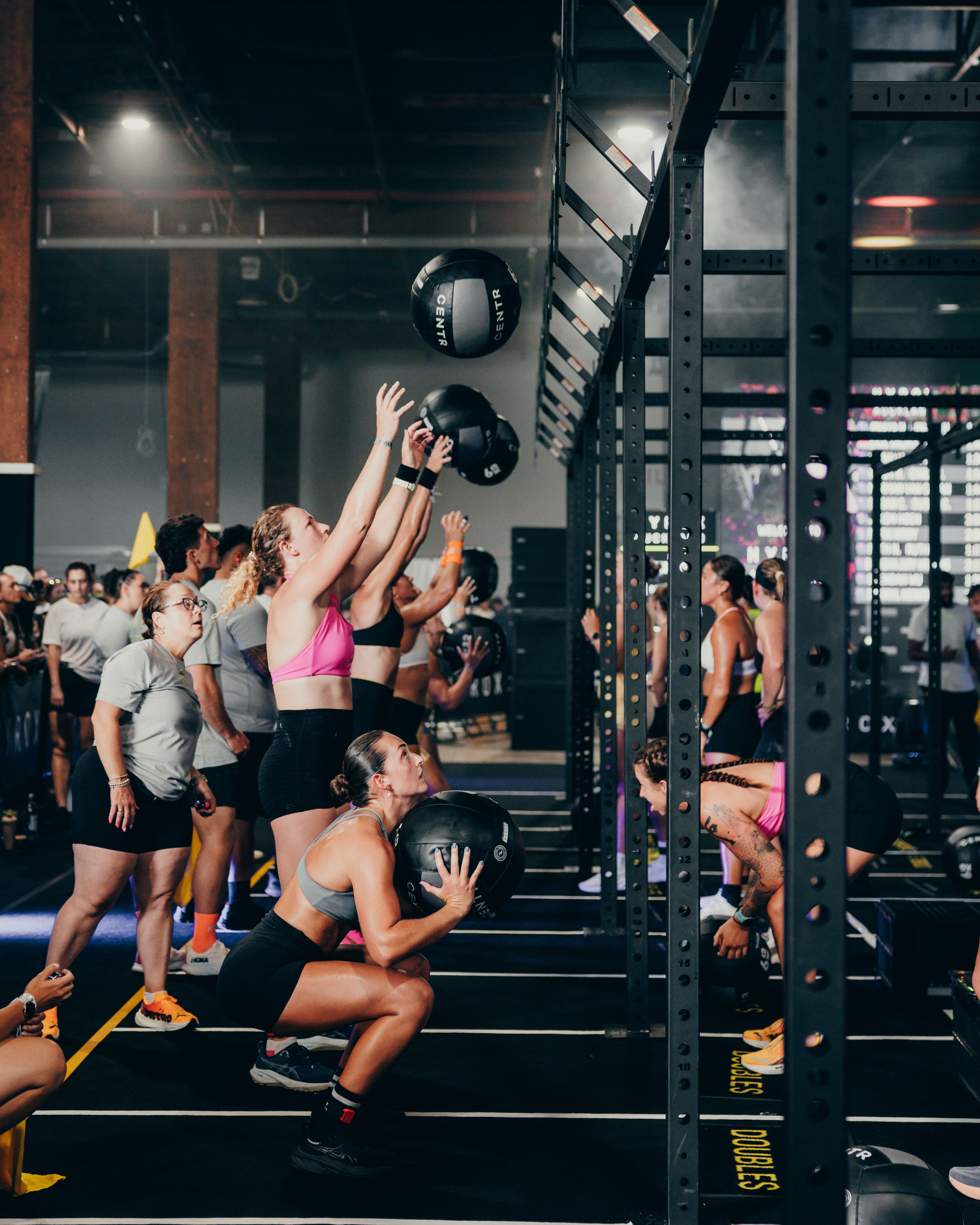 HYROX event competitors engaging in the wall balls station