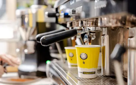 Aphotoofsomeonedippingaspoonintoacupofcoffee