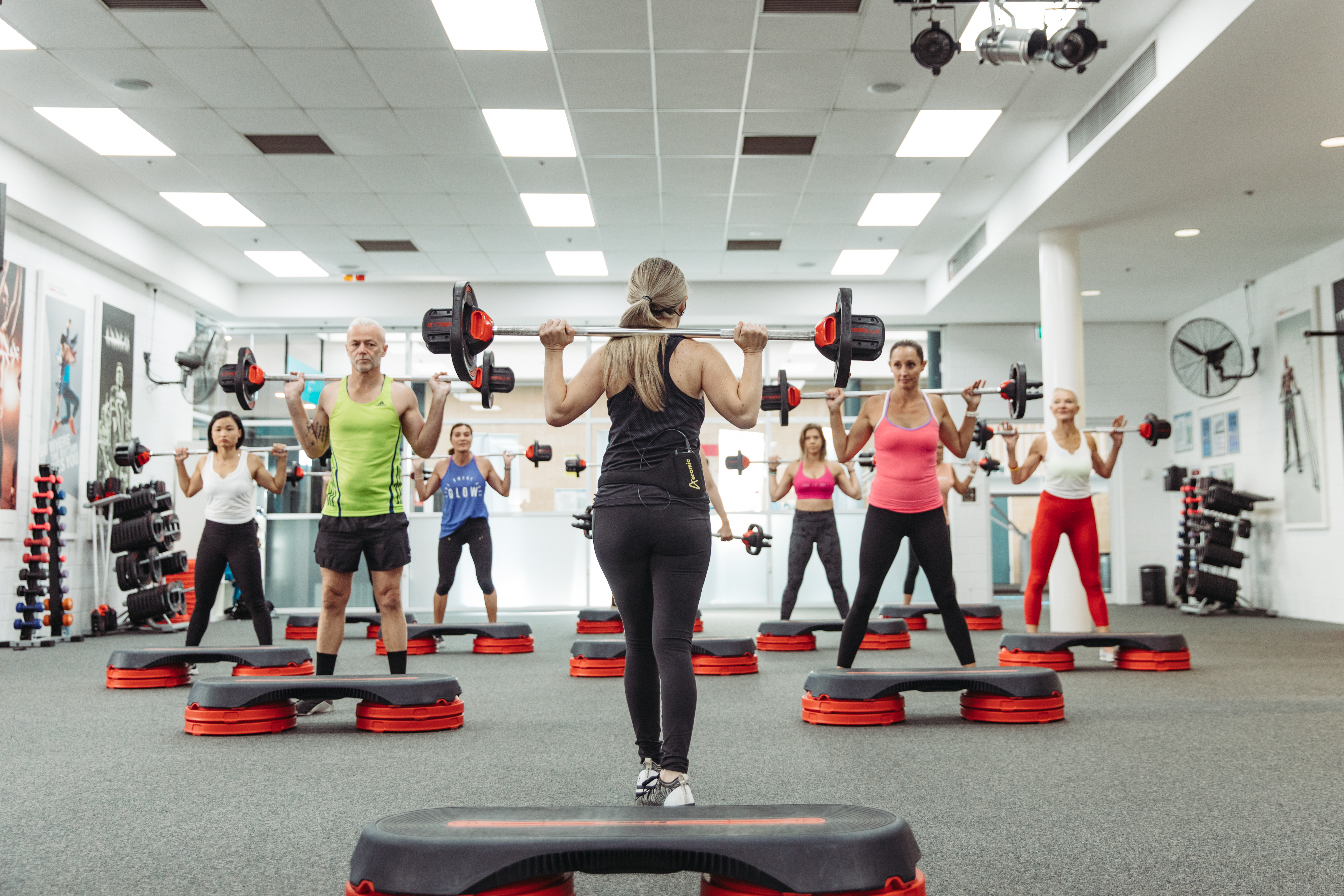 A photo of a fitness instructor leading a group fitness class