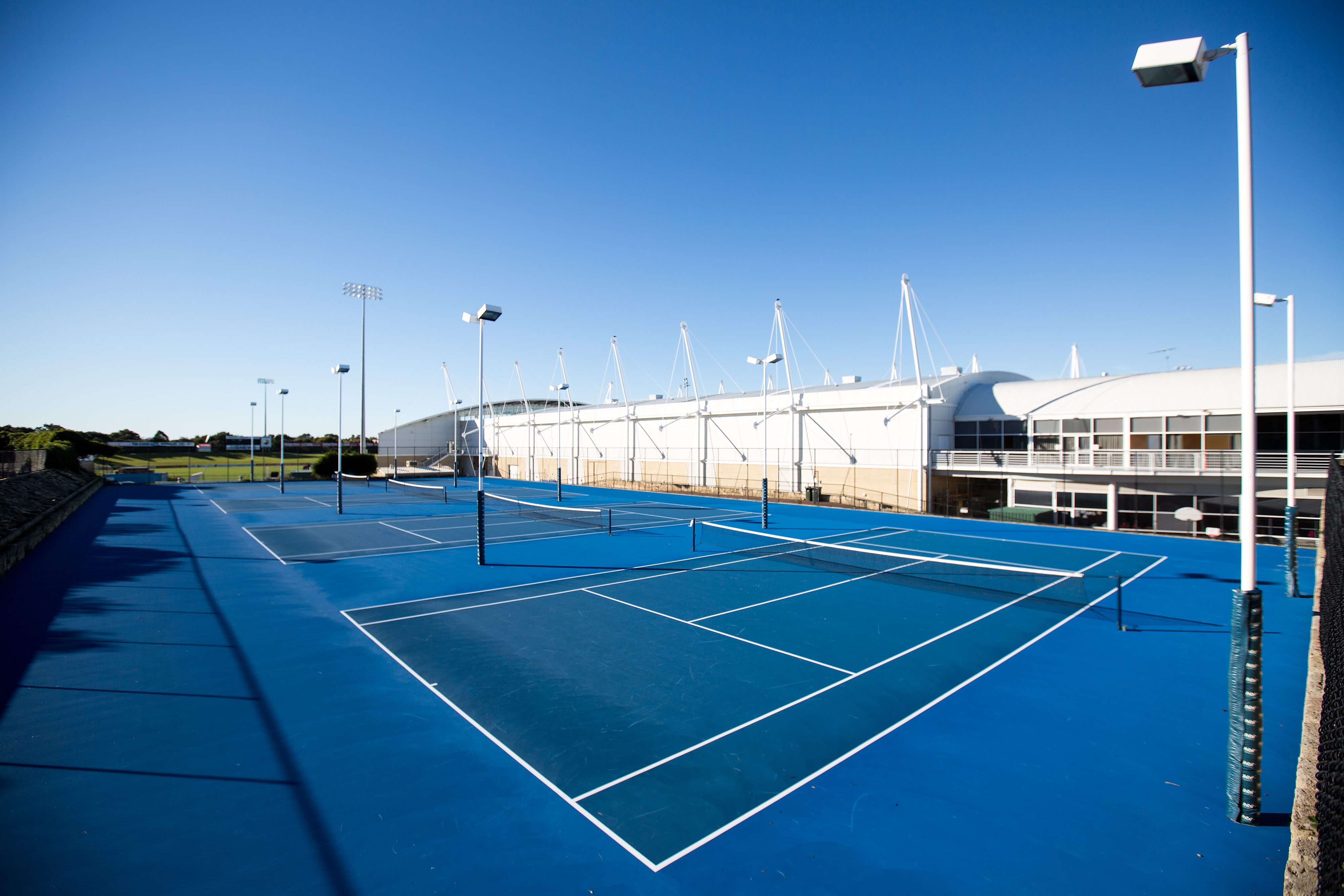 A photo of the outdoor tennis courts located at HBF Arena in Joondalup, Perth