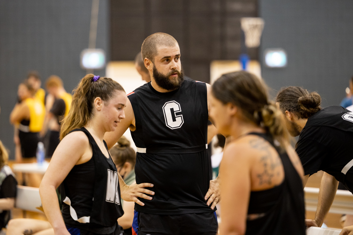 Mixed netball players talking tactics