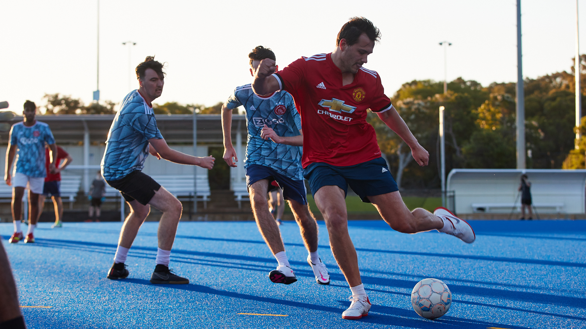 Man kicking the ball during men's 6-a-side soccer game