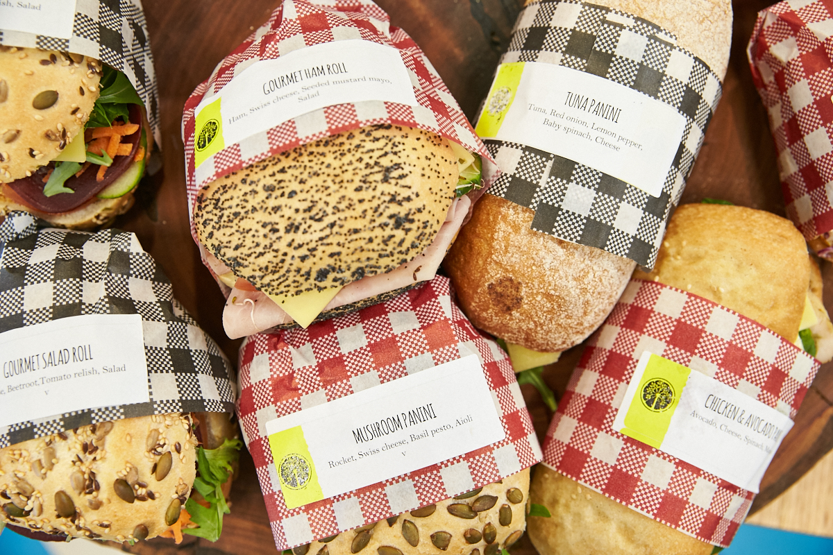 A top down photo of assorted rolls and paninis